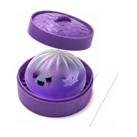 Ghost Dumpling Squishy Halloween toy in its mini steamer basket